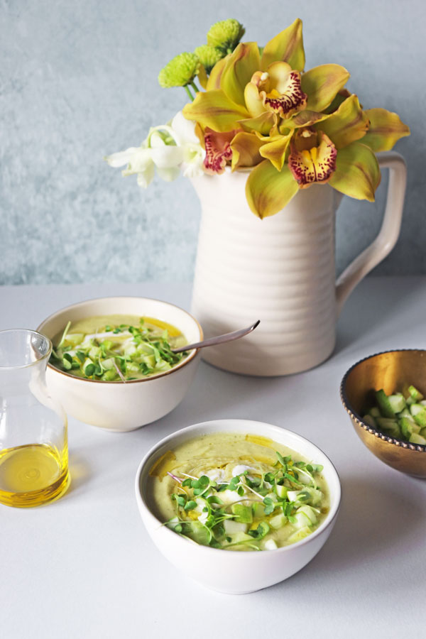 bowls of avocado cucumber gazpacho with bright summer flowers